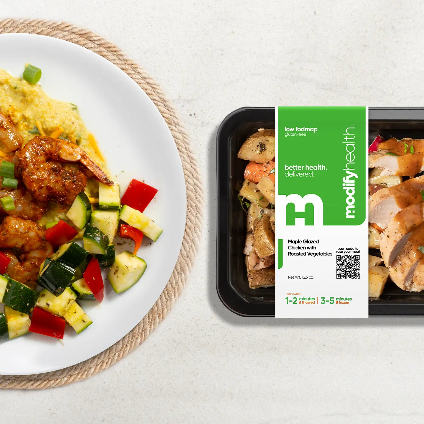 ModifyHealth low-FODMAP meal tray beside a plated chicken and vegetable meal