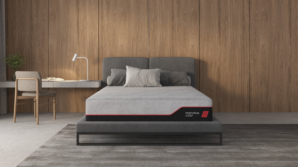 PerformaSleep 2.0 gray mattress with black sides and red trim in a minimalist bedroom