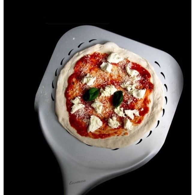 Unbaked pizza resting on a Pizza Party Essenza perforated aluminum pizza peel