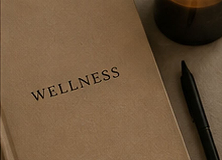 Wellness journal and candle for a quiet at-home ritual