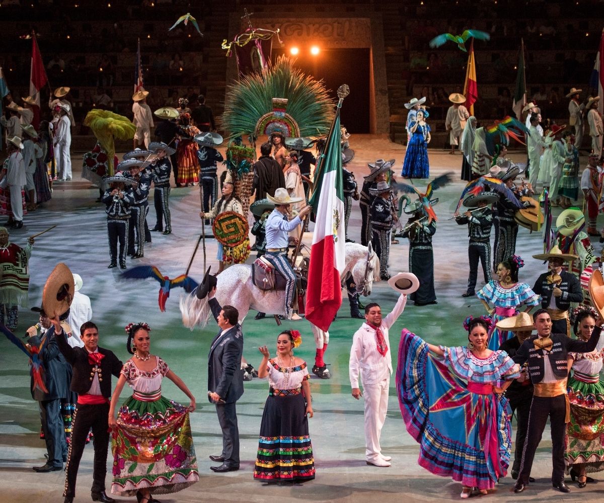 Costumed dancers and performers during Xcaret Mexico Espectacular at Gran Tlachco theater