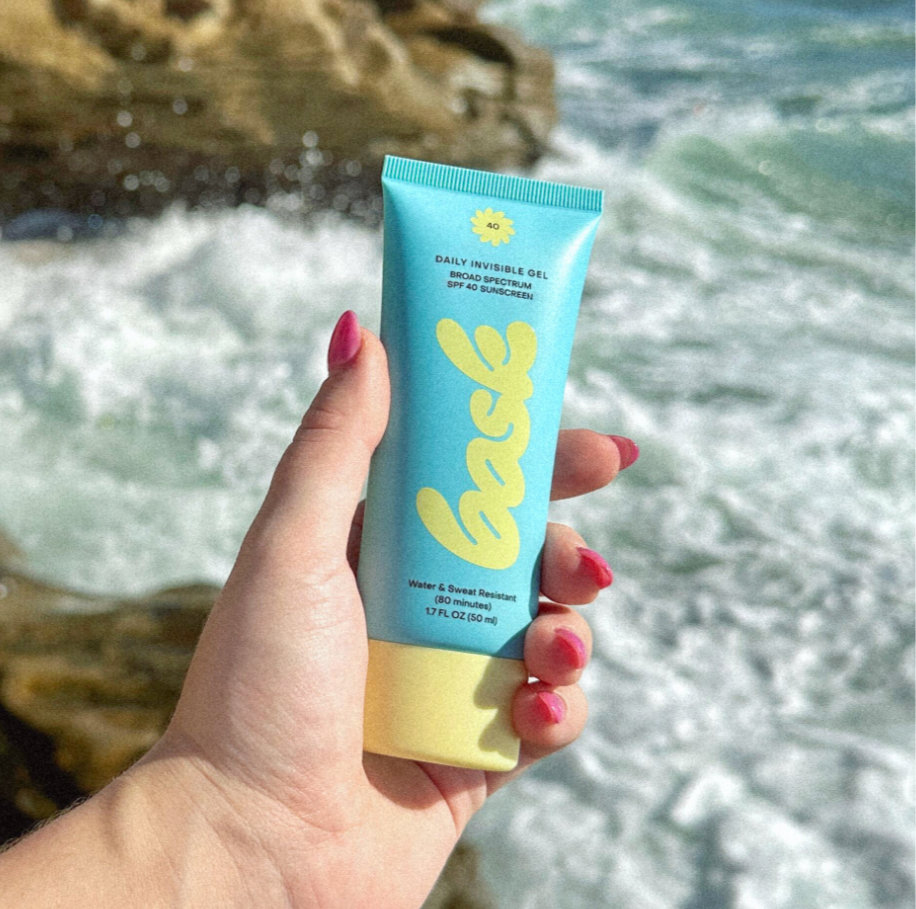 Bask Daily Invisible Gel SPF 40 sunscreen by the ocean