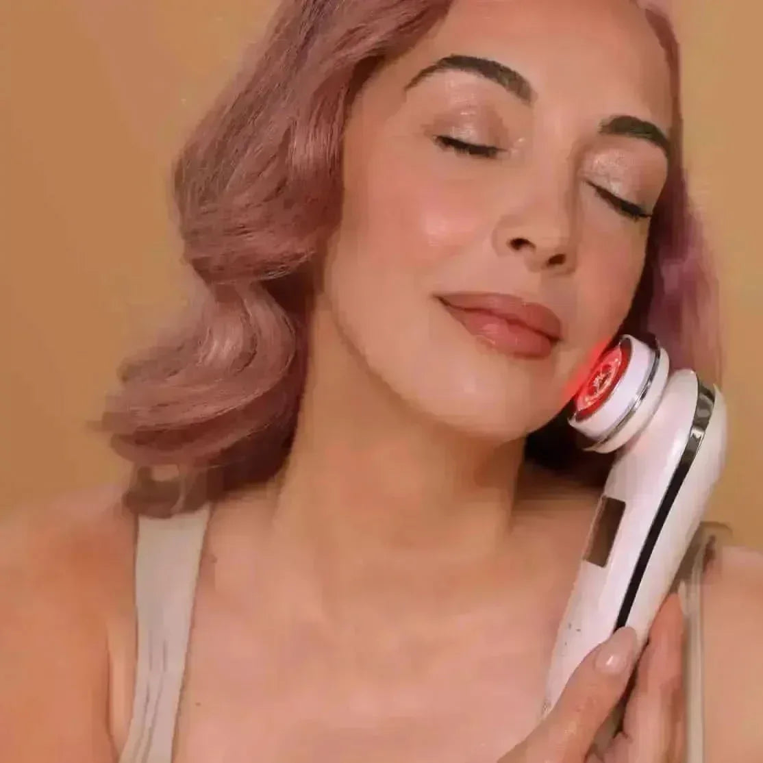 Woman using the EvenSkyn Lumo facial skincare device